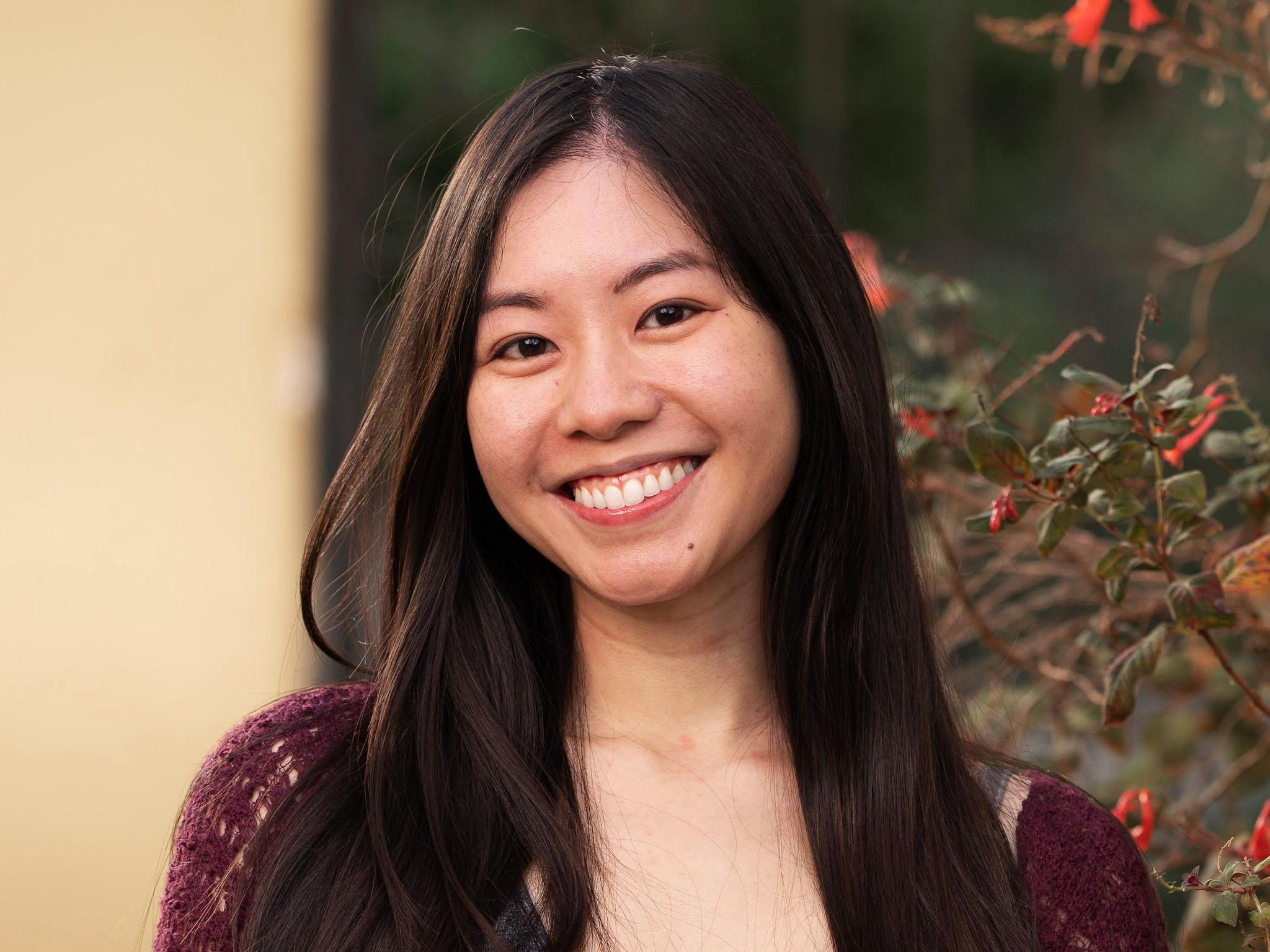A pictue of a woman smiling confidently after her Hairline Lowering Surgery by Dr. Jae Pak