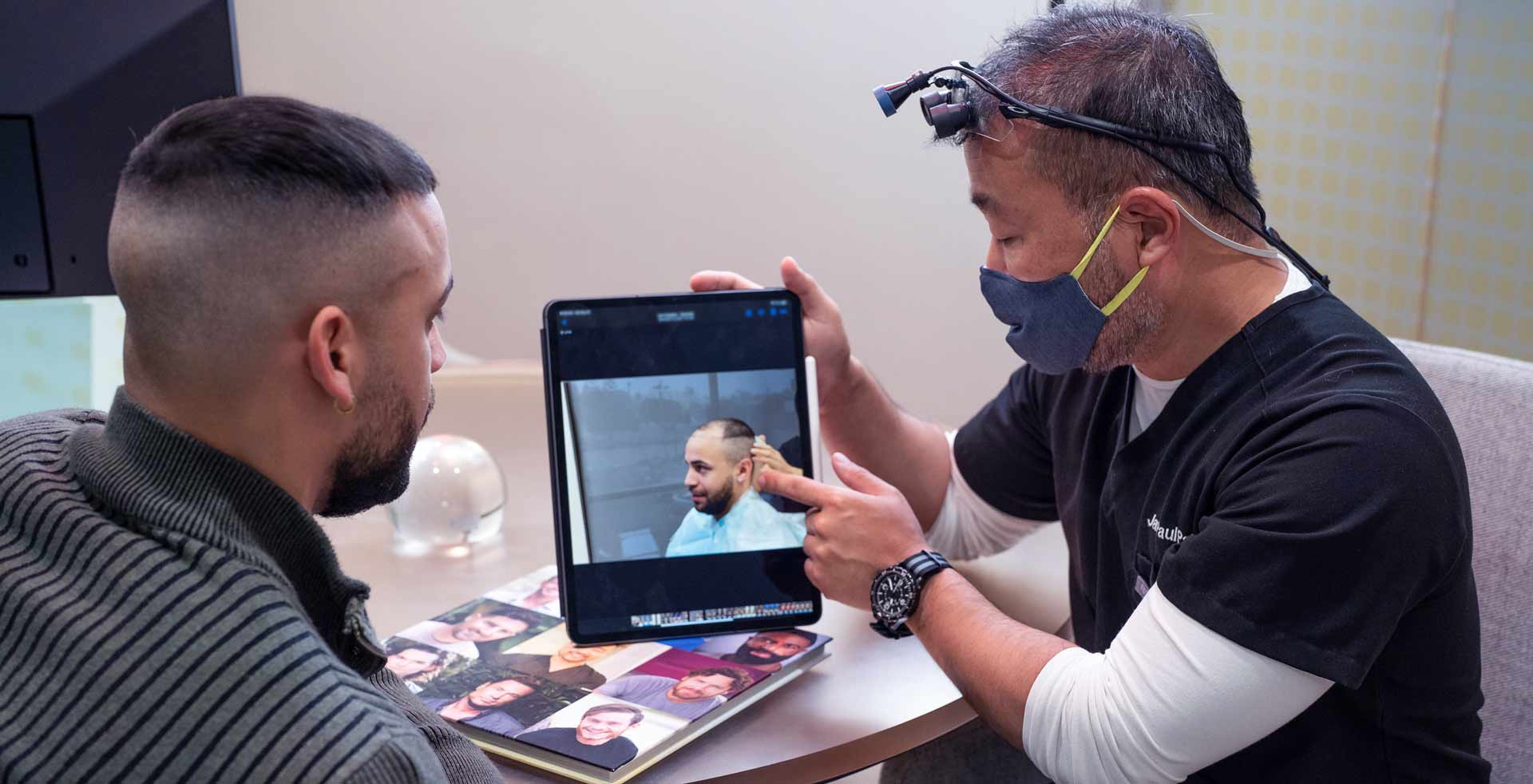 an image of Dr. Pak explaining to his patient the hairliine restoration procedure